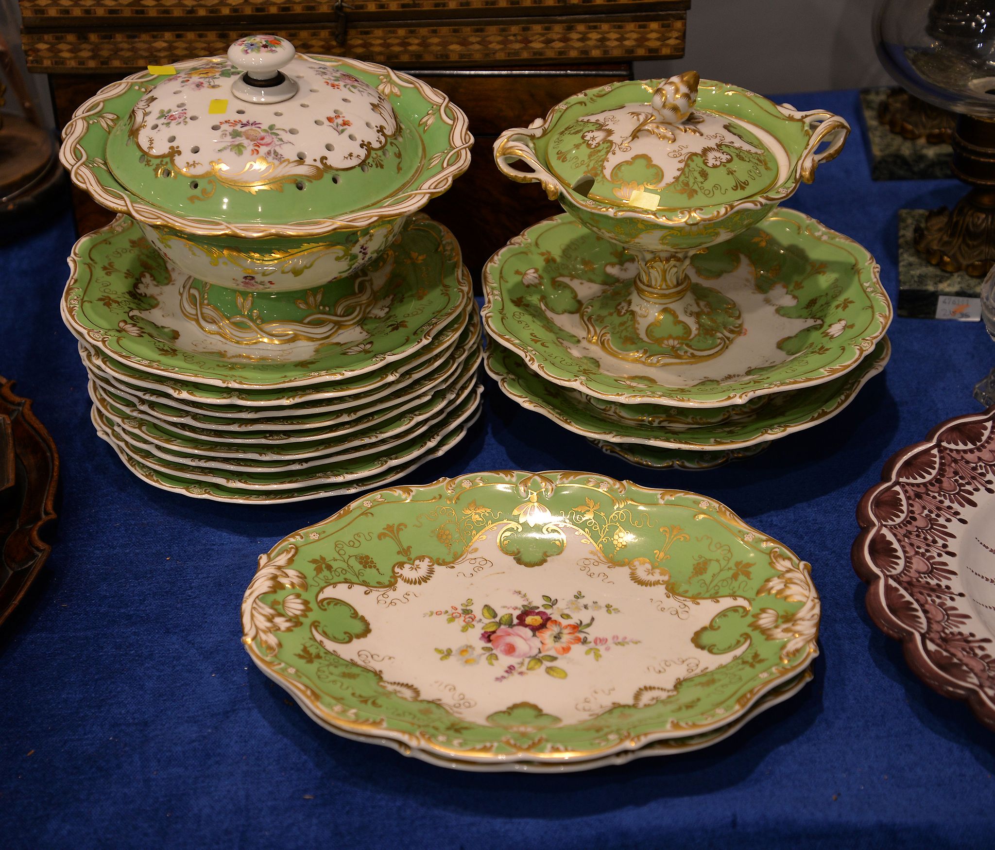 An English porcelain green ground and gilt Rococco revival part desert service, comprising a cream