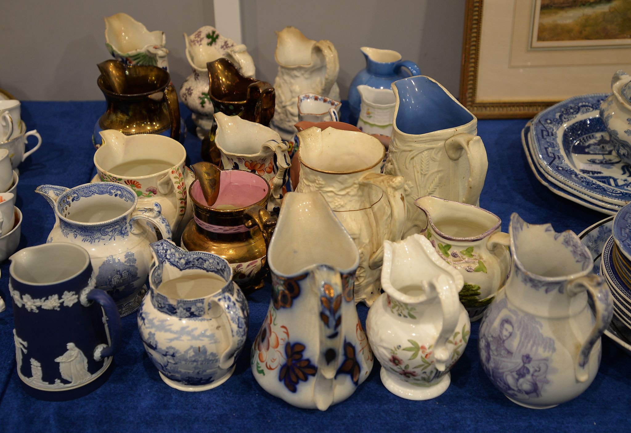 An early 19th century 'Newcastle' pearlware relief moulded jug, the handle with hound's head