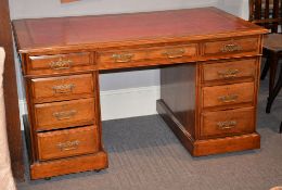 A walnut twin-pedestal desk, circa 1900, with red leather inset top, 78cm high, 137cm wide, 75cm