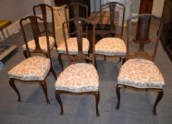 A set of six dining chairs, circa 1930, each with paterae and bell flowers to the vertical splat