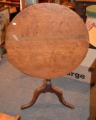 A George III oak tripod table, 79cm diameter