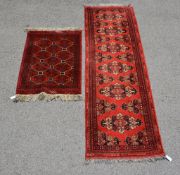 A runner of Turkish design, the red field decorated with geometric motifs, approximately 83 x 283cm,