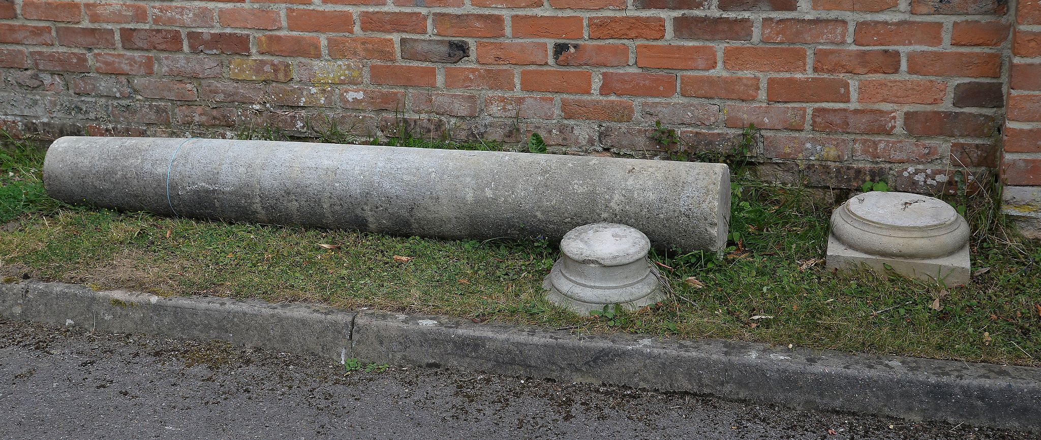 A stone composition column, 20th century, of Doric order, with circular capital, tapered shaft,