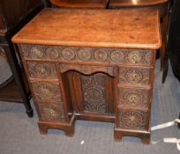 A George III oak kneehole desk, with later carved decoration, 78cm high, 81cm wide, 51cm deep