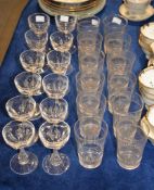 A set of twelve late 19th century facet cut wine glasses, and a set of twelve late 19th century