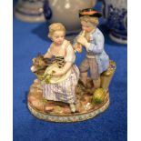 A Meissen group of two children with a goat, late 19th century, modelled wearing 18th century dress