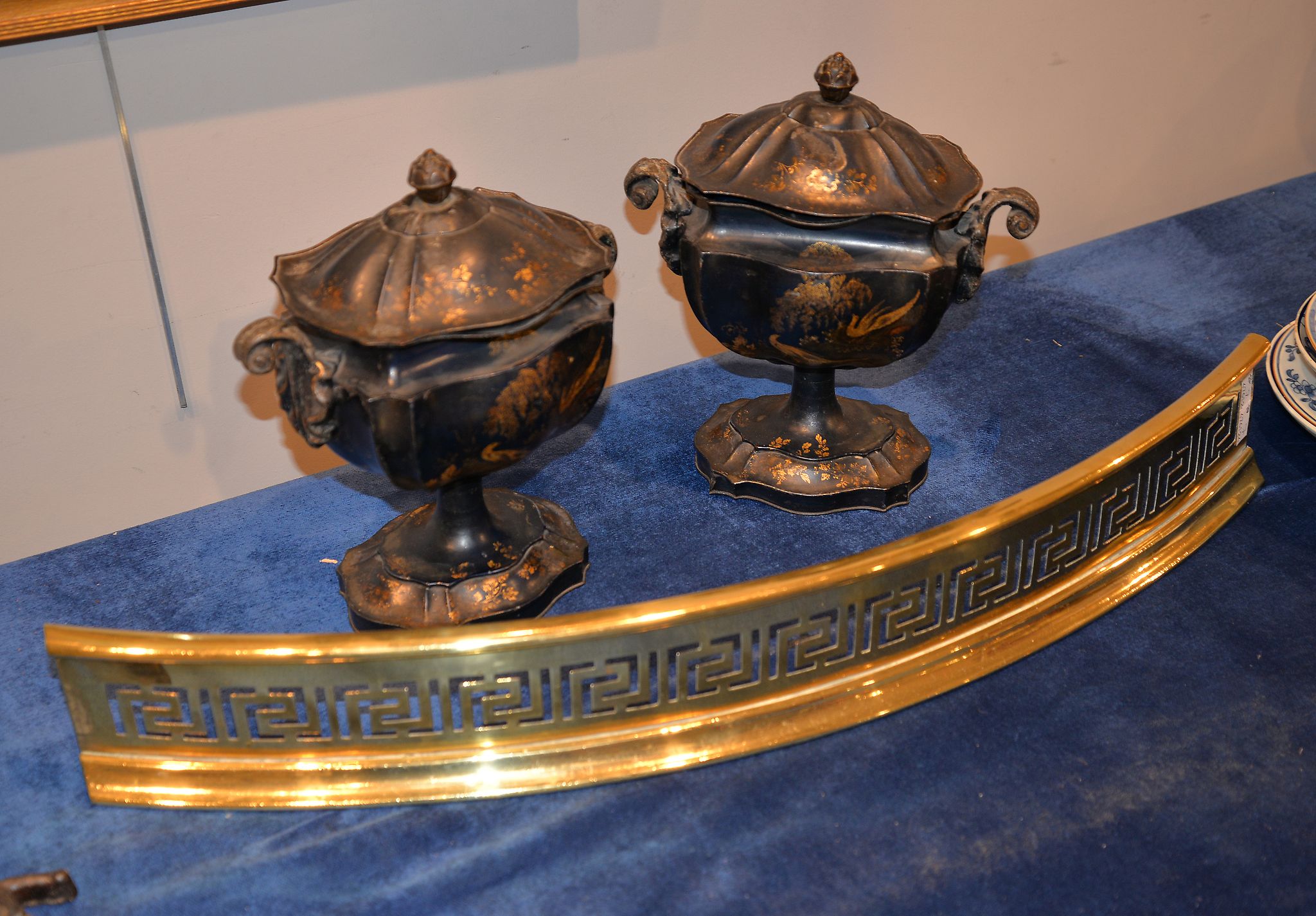 A pair of 19th century Pontypool tôle ware chestnut urns with black ground and parcel gilt