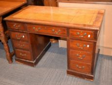 A late Victorian mahogany pedestal desk, the leather inset rectangular top above three frieze