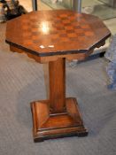 Ω An octagonal pedestal rosewood veneered games table, 77cm high, the top 61cm x 60cm