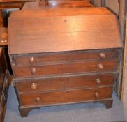 A 19th century oak bureau, with fittings enclosed by a fall, above four long drawers