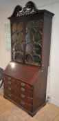 A George III mahogany bureau, the fall enclosing a fitted interior with pigeonholes and drawers,