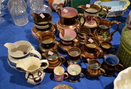 A selection of British pottery copper lustre and other jugs including a commemorative example for