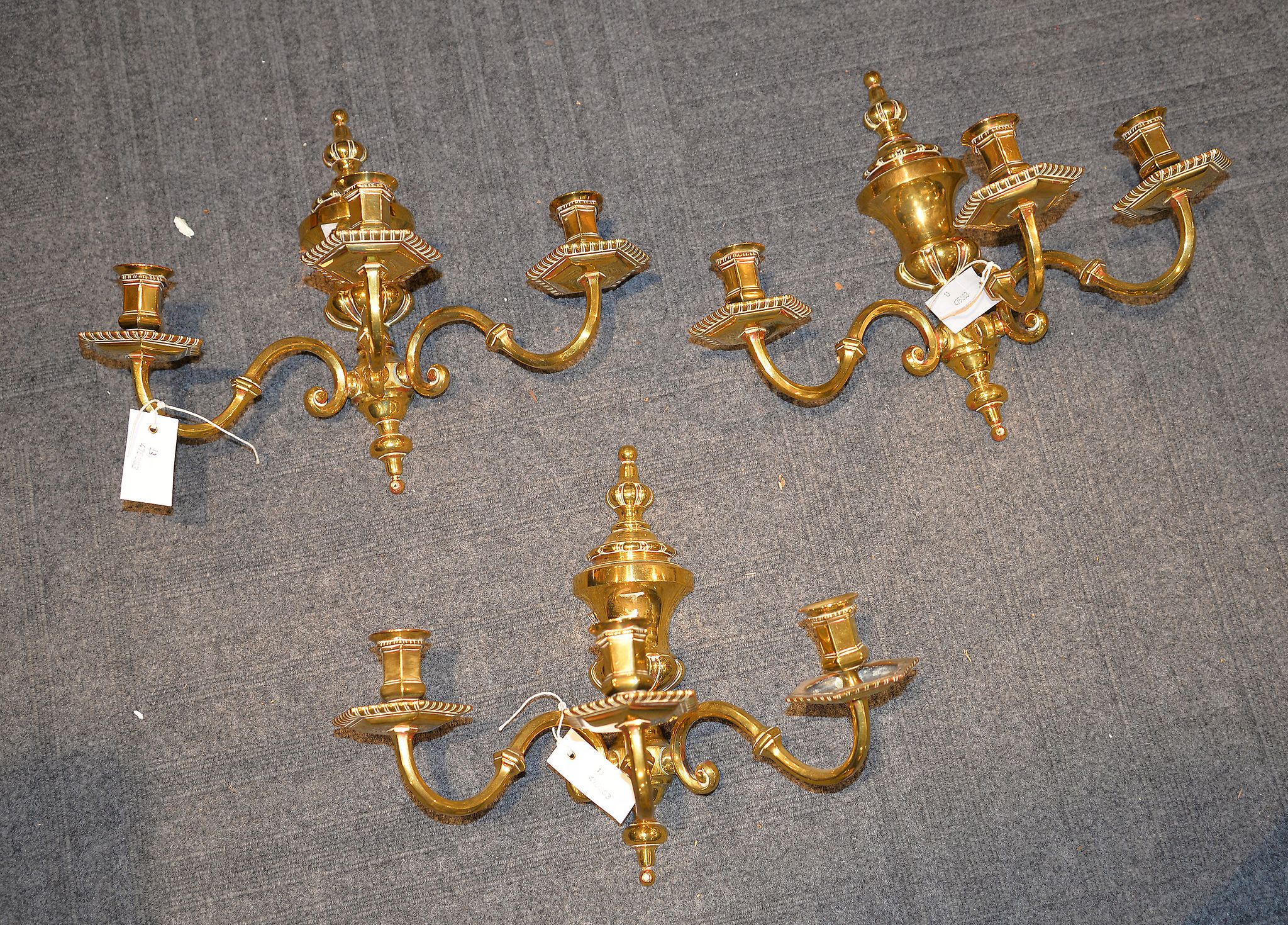 A set of three brass three light wall appliques, 20th century, 33cm high, 43cm wide