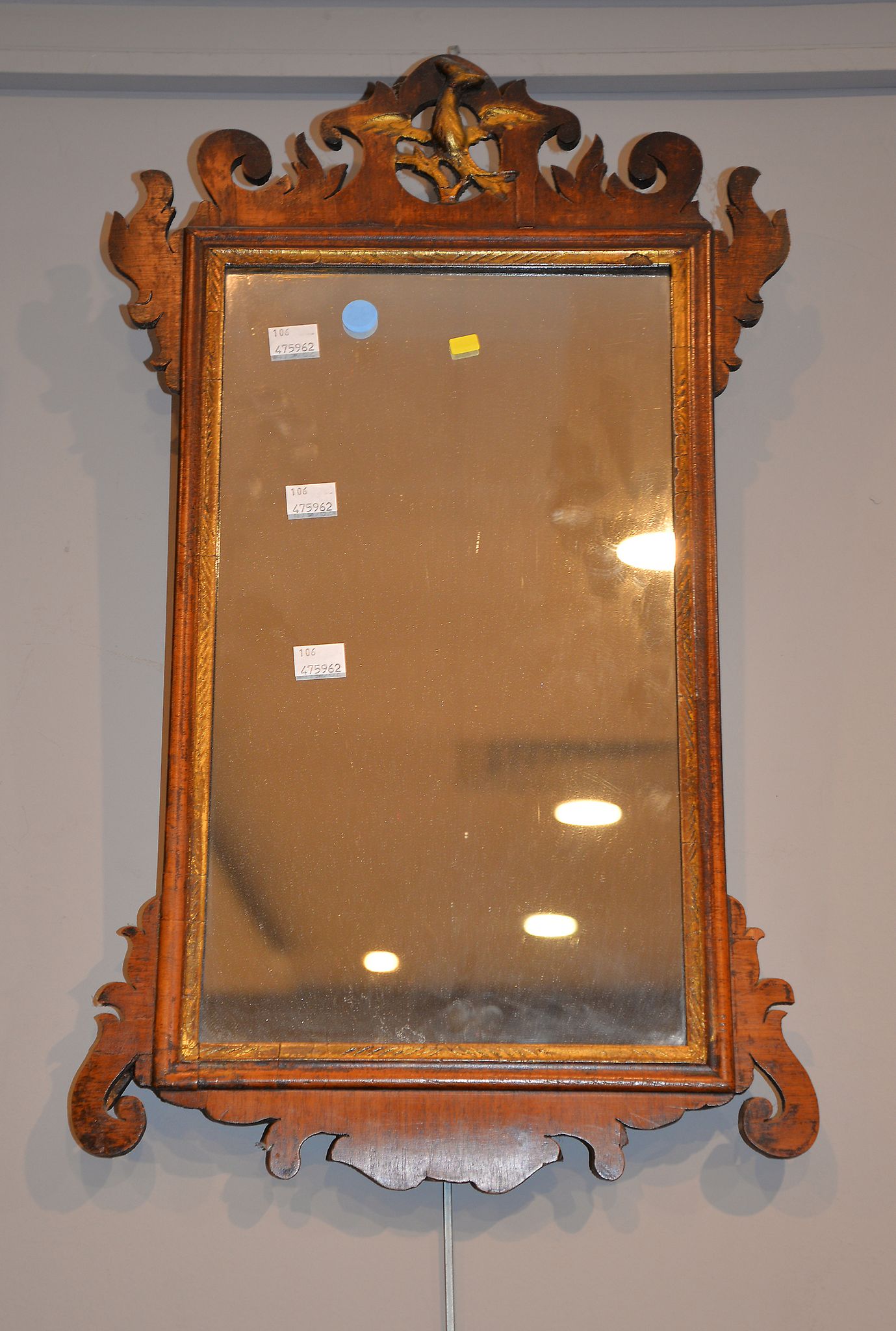 A George III walnut and parcel-gilt fret-frame wall-mirror, 61cm x 37cm