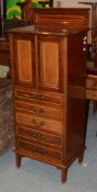 An Edwardian music cabinet, the cupboard doors enclosing slides, 144cm high