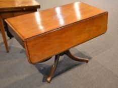 A walnut Pembroke table, 19th century, with a blind frieze drawer to one short end, above a turned