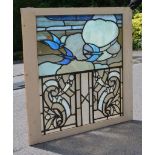 Five Arts and Crafts painted glass window panels, one 62.5cm x 82cm, in the original window frame;