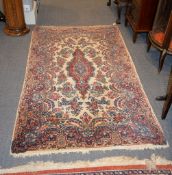 A Qum rug, with a cream ground decorated with a floral medallion and spandrels, approximately