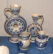 Four various German stoneware jugs of Mettlach type, the largest 34cm high