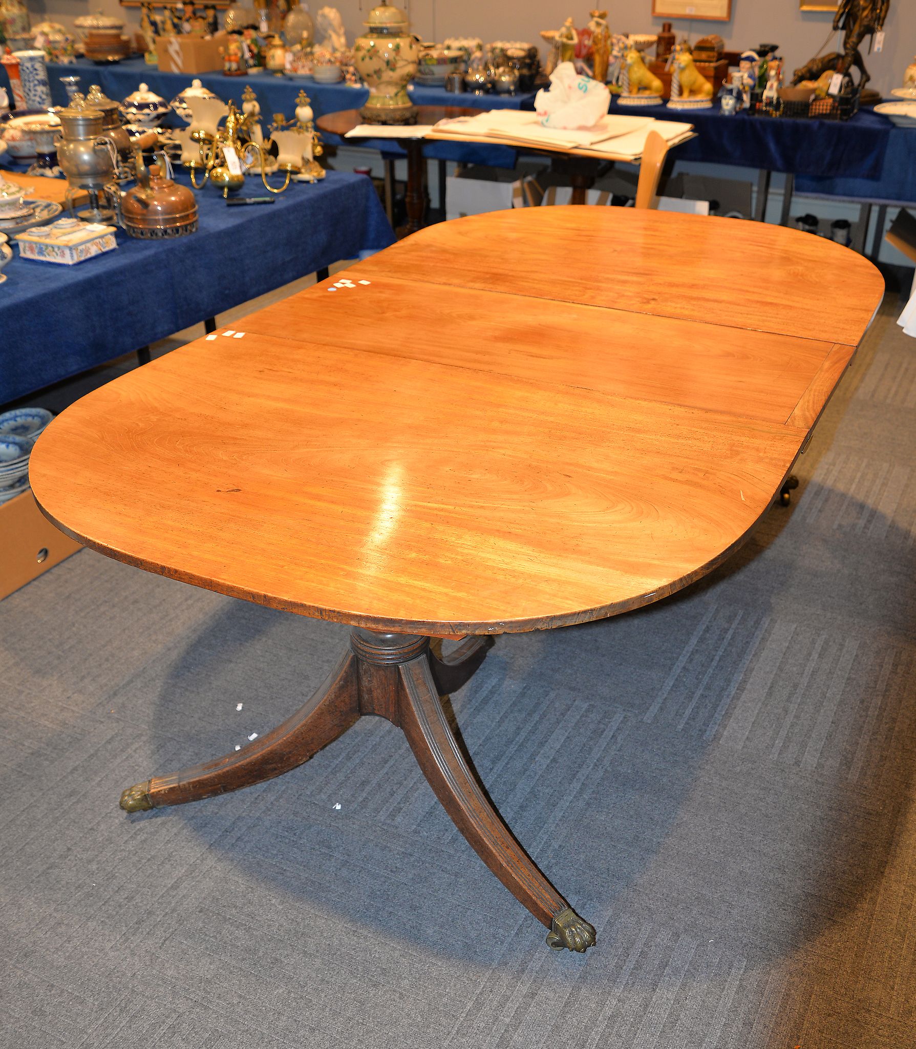 A mahogany twin pedestal dining table, 19th century and later, with one associated additional leaf