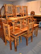 A modern striated hardwood dining table, 77cm high, 181cm long, 92cm wide, and a set of six chairs