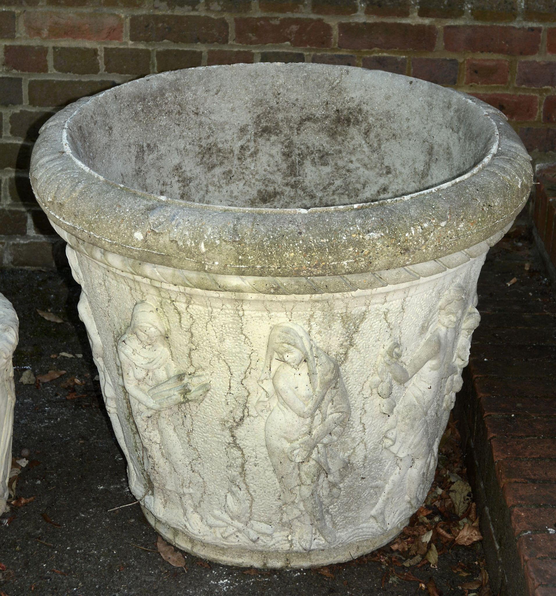 A large stone composition garden urn, modern, the exterior cast with a figural scene in relief, 71cm