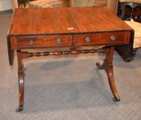 A Regency mahogany sofa table, the moulded rectangular twin top above two drawers on rectangular