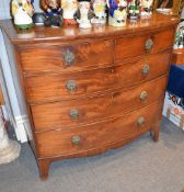 A Scottish early 19th century bowfront chest of drawers, with two short and three long drawers,