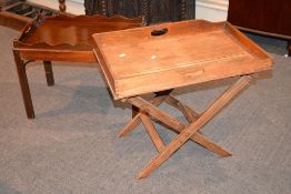 An oak butlers tray on folding stand, 59cm high overall, the tray 70cm x 44cm, together with a