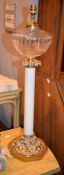 A late-Victorian opaque white and clear glass gilt metal mounted paraffin lamp, of columnar form,