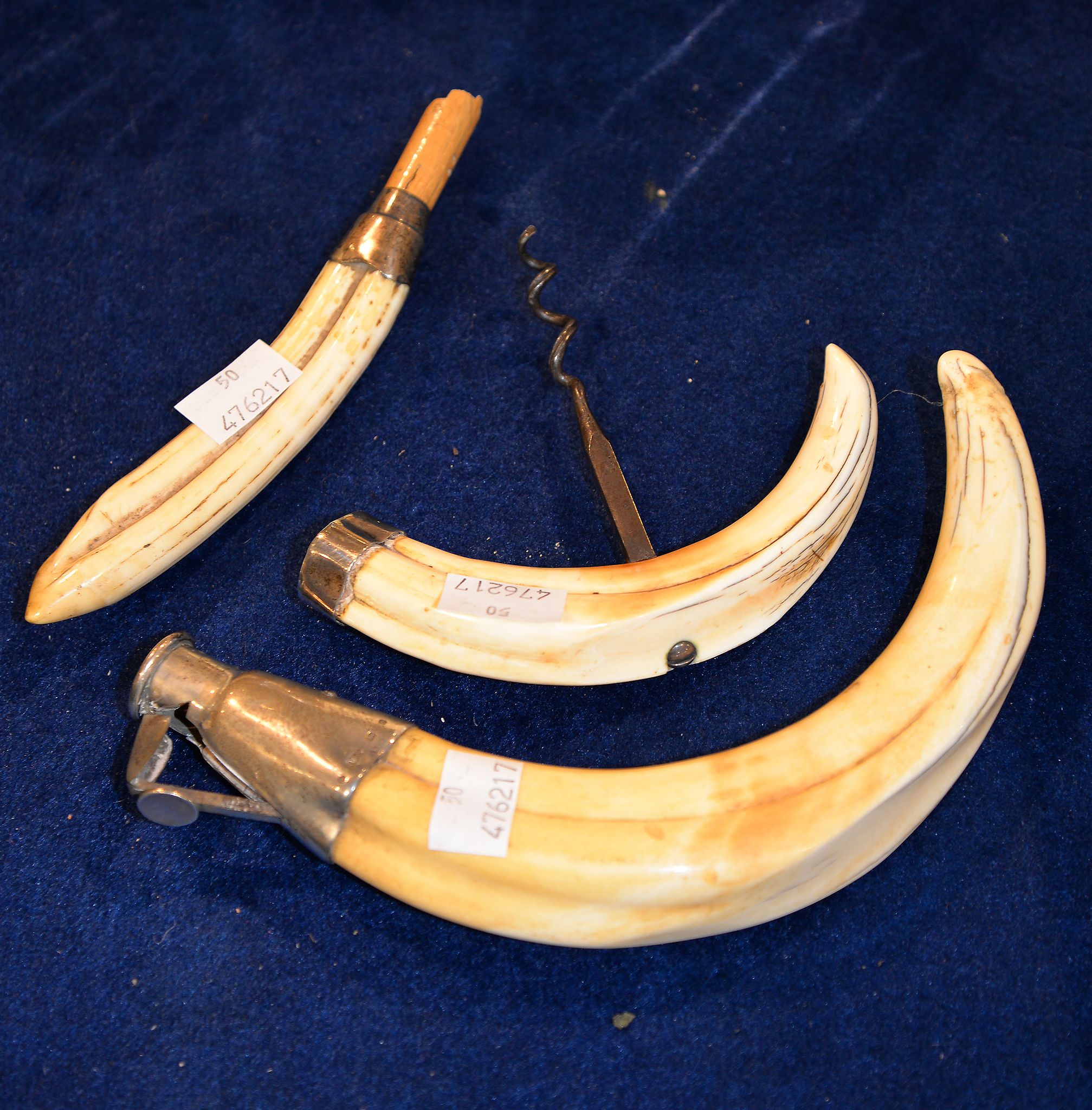 A silver mounted tusk cigar cutter, a similar bottle opener and a silver mounted tusk