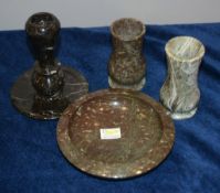 Four serpentine marble items including a taperstick, a dish, and two baluster vases