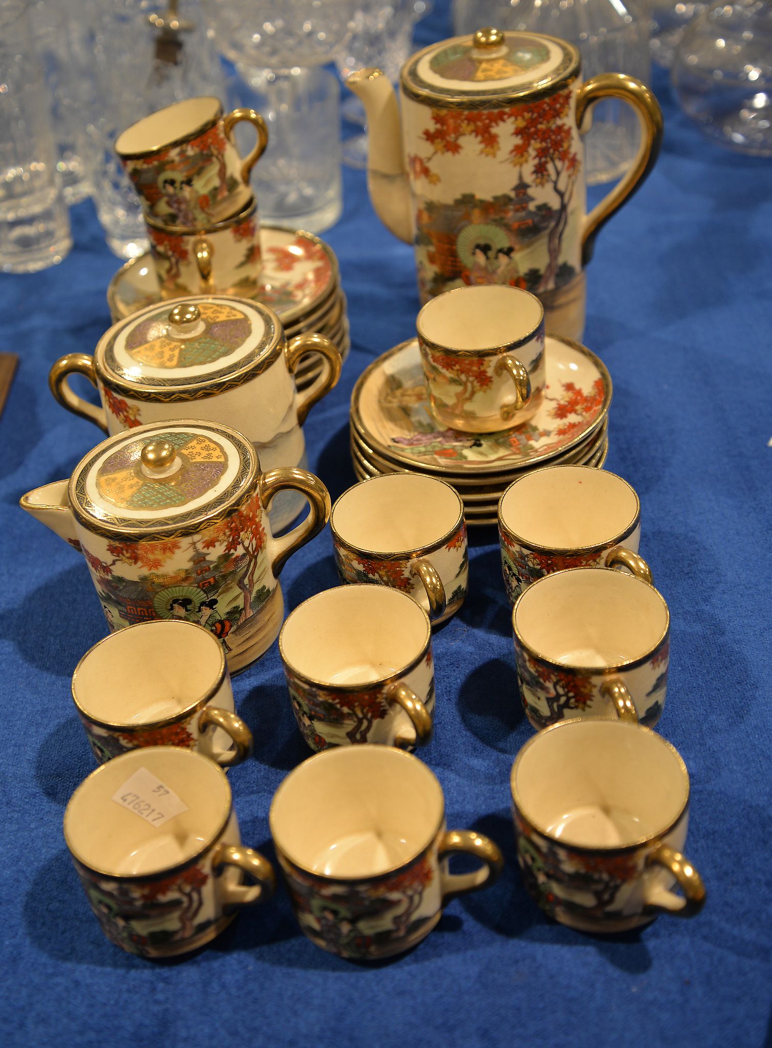 A Japanese Satsuma earthenware coffee service, decorated in coloured enamels and gilt with figures