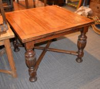 An oak drawer leaf extending dining table in Antiquarian style, mid 20th century, with carved