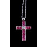 A ruby and diamond cross pendant, the French cut rubies in channel settings with a central step cut
