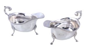A pair of oval sauce boats by Asprey & Co. Ltd., Sheffield 1966, with leaf capped flying scroll