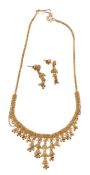 An Indian gold coloured necklace and ear pendants, the articulated graduated fringe necklace with