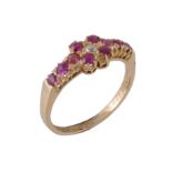 An Edwardian ruby and diamond ring, the quatrefoil of rubies with an old cut diamond to the centre,