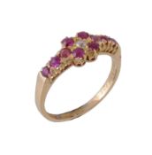 An Edwardian ruby and diamond ring, the quatrefoil of rubies with an old cut diamond to the centre,