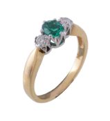 An emerald and diamond ring, the central oval cut emerald claw set between two brilliant cut