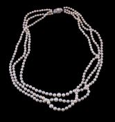 A three strand cultured pearl necklace by Mikimoto, composed of graduating cultured pearls, to the