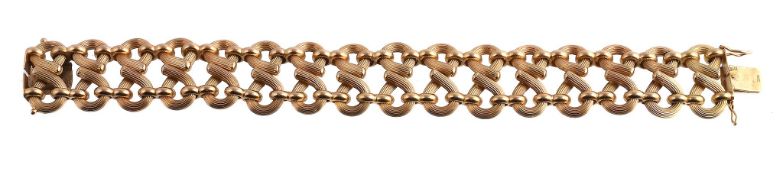 An 18 carat gold bracelet by Weingrill, retailed by Asprey & Co., composed of reeded figure of