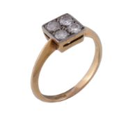 A 1920s four stone diamond ring , the old brilliant cut diamonds in a squared millegrained setting,