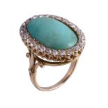 A turquoise and diamond ring, the oval cabochon turquoise within a surround of old brilliant cut