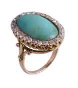 A turquoise and diamond ring, the oval cabochon turquoise within a surround of old brilliant cut