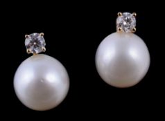 A pair of cultured pearl and diamond ear studs, the cultured pearls set below a brilliant cut