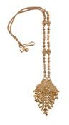An Indian gold coloured necklace, the pierced beaded panel suspending beaded fringes, to a fancy