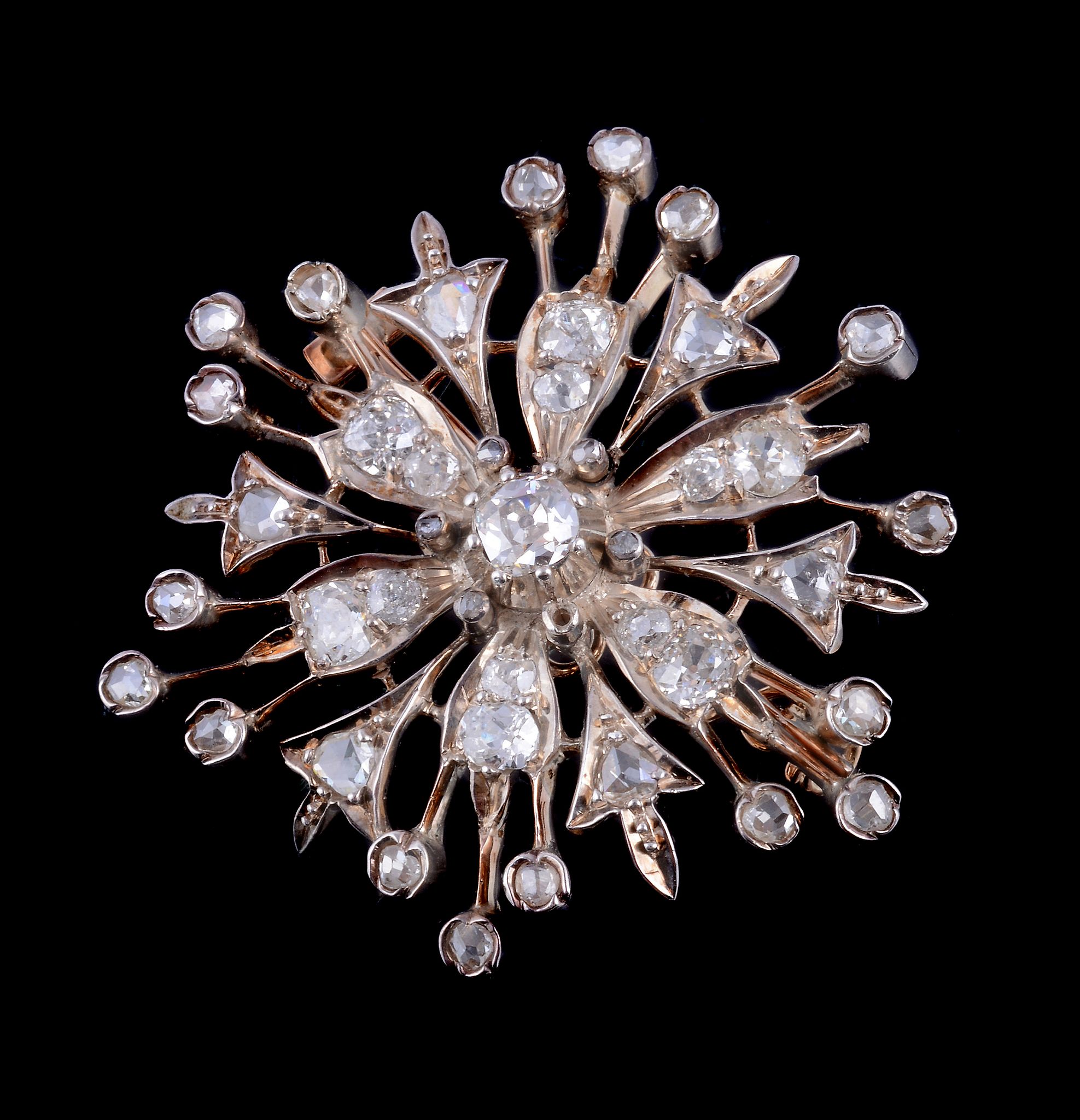 A Victorian diamond set flower head brooch, circa 1880, the pierced flower head set with old cut