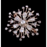 A Victorian diamond set flower head brooch, circa 1880, the pierced flower head set with old cut