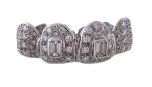A diamond set dental grill, with pave set diamond teeth, two with central step cut diamonds with